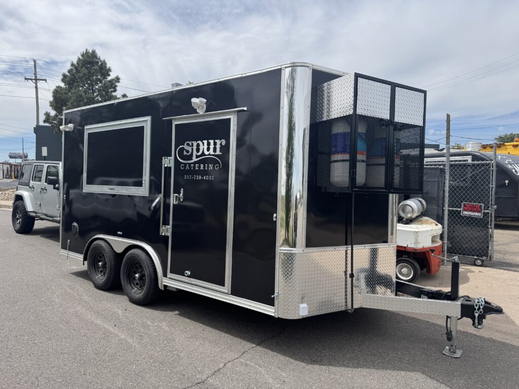 Spur Catering 14ft food trailer built by Mile High Foodtrucks, black exterior with service window, delivered to Jackson Hole, Wyoming