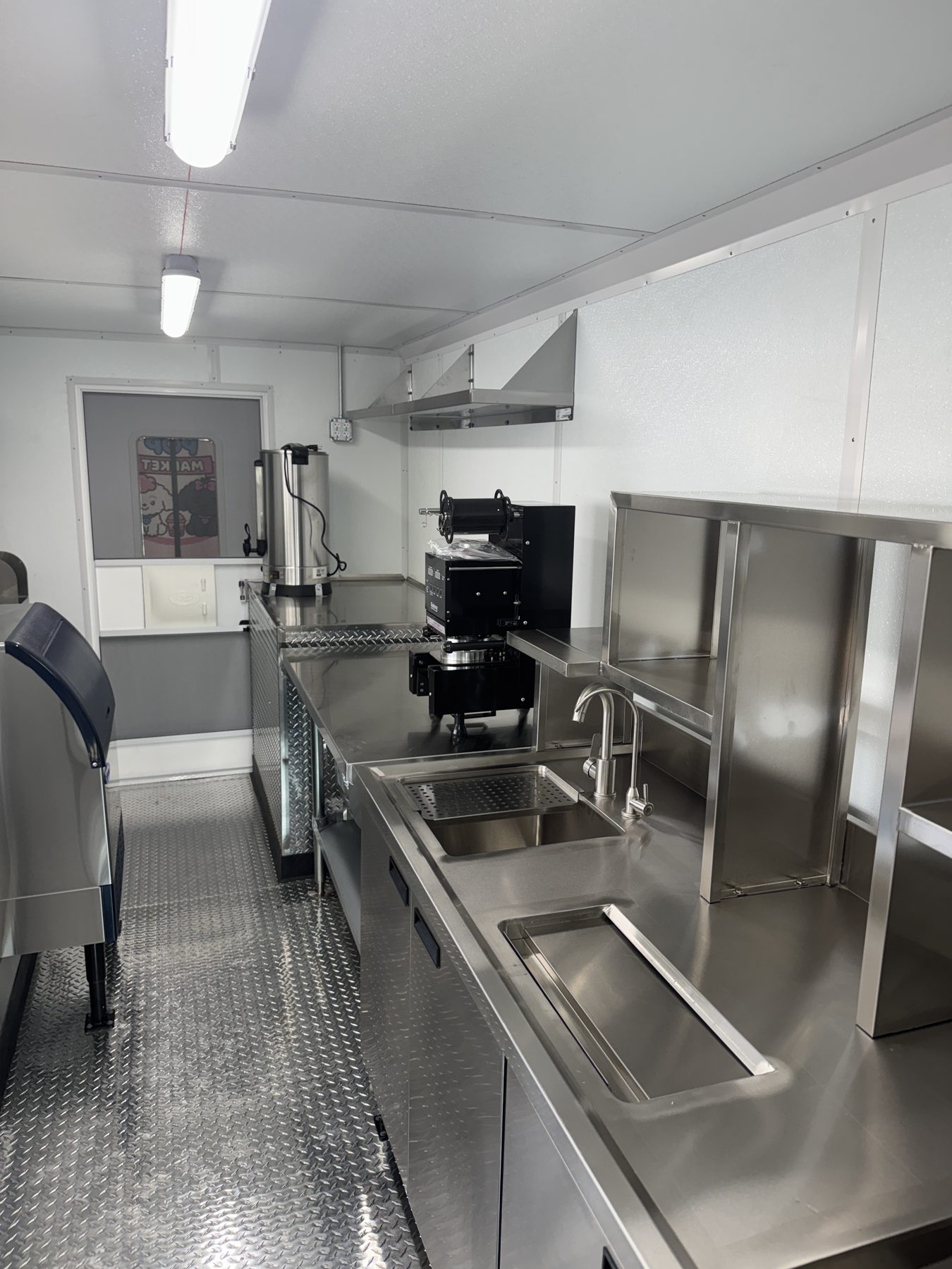 Interior of the 14ft boba truck showing the bubble tea workstation, cup sealer and hot water boiler