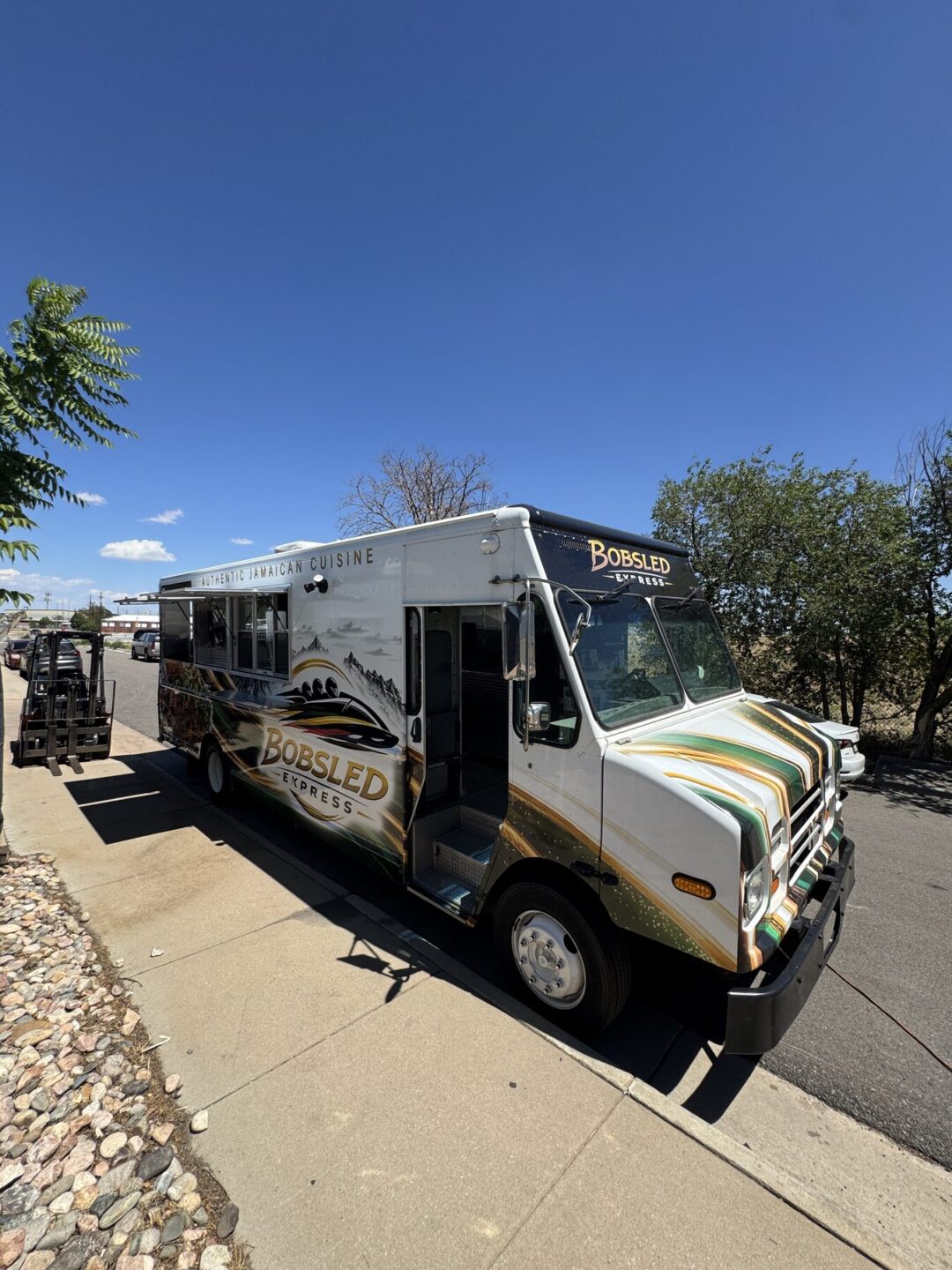 Front three quarter view of the finished jerk chicken food truck before delivery to Laramie, Wyoming