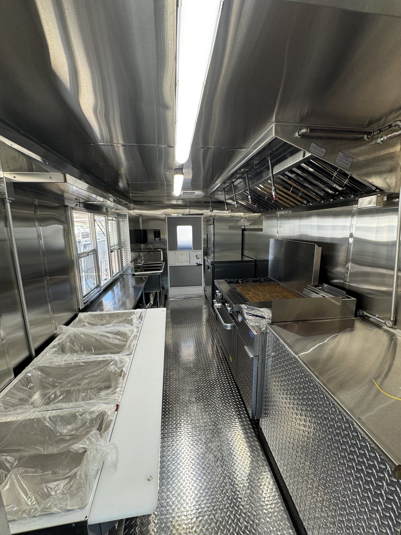 Interior of the food truck looking toward the fryer and the service window counter