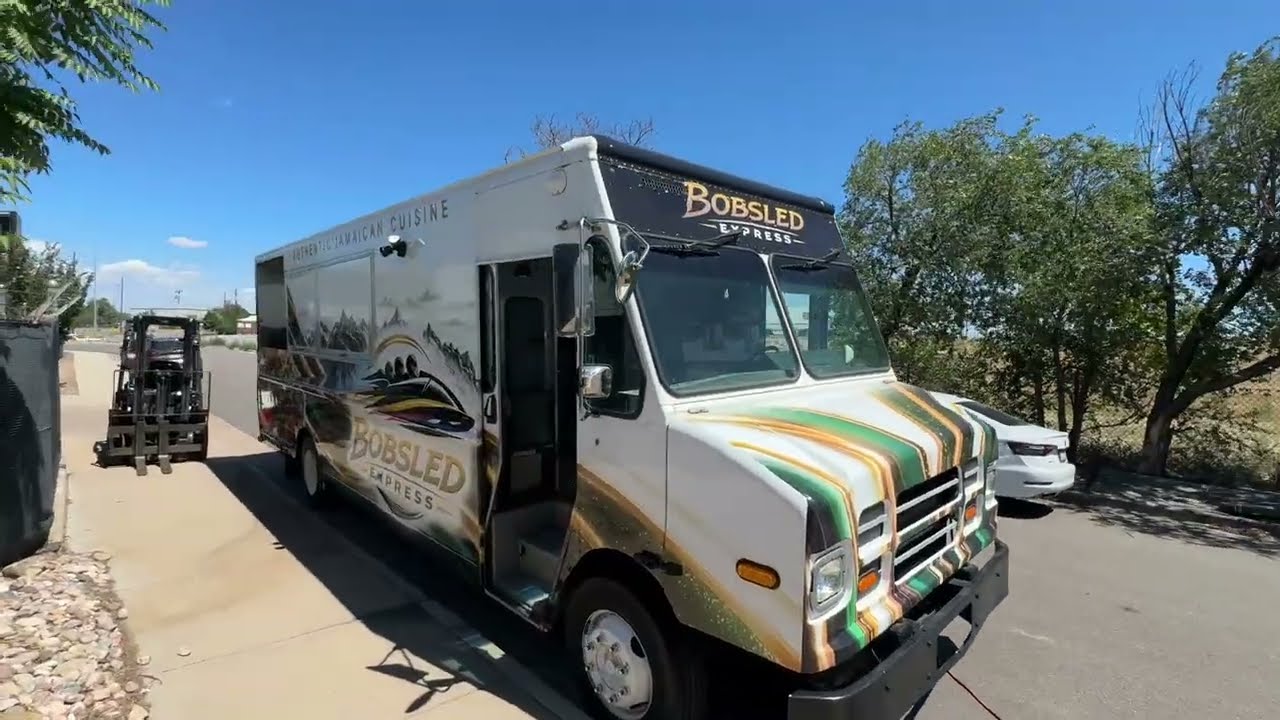Jamaican jerk chicken food truck built for Laramie, Wyoming, street side with the six foot service window