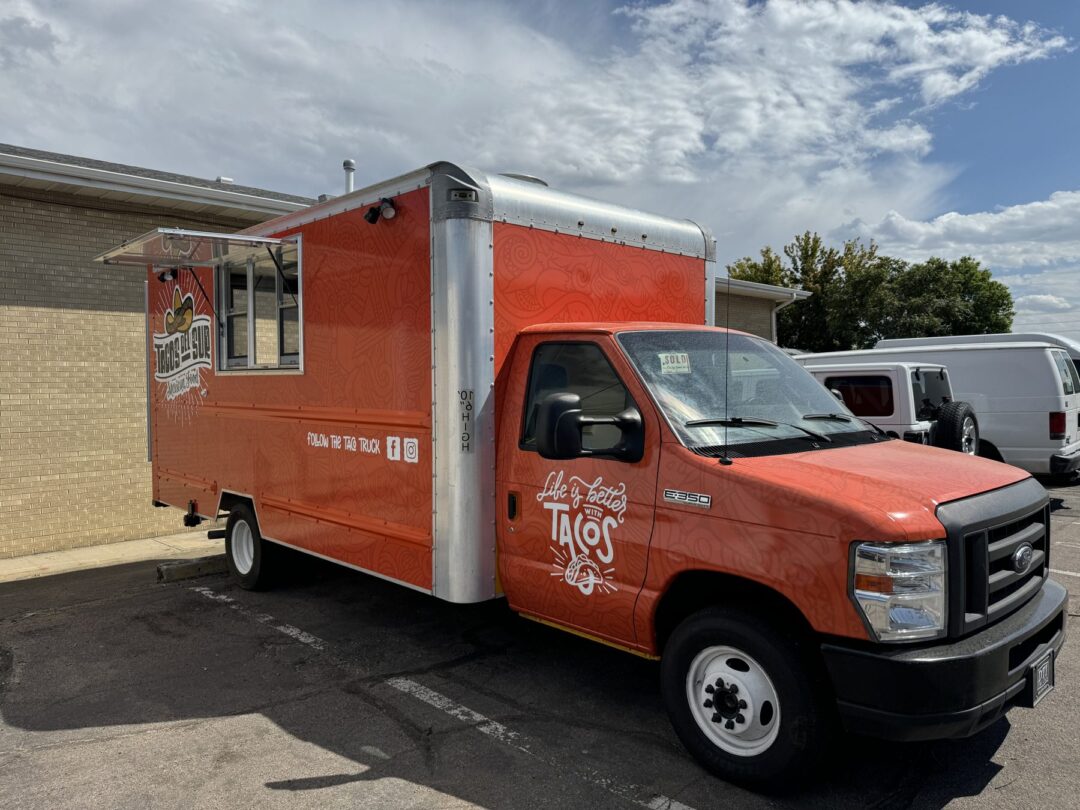 Orange Tacos del Sur taco food truck, a 16ft Ford E350 box truck conversion built for Aurora, Colorado