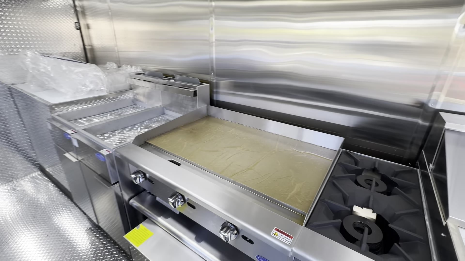 Atosa CookRite 36 inch griddle and two burner hotplate on a refrigerated chef base
