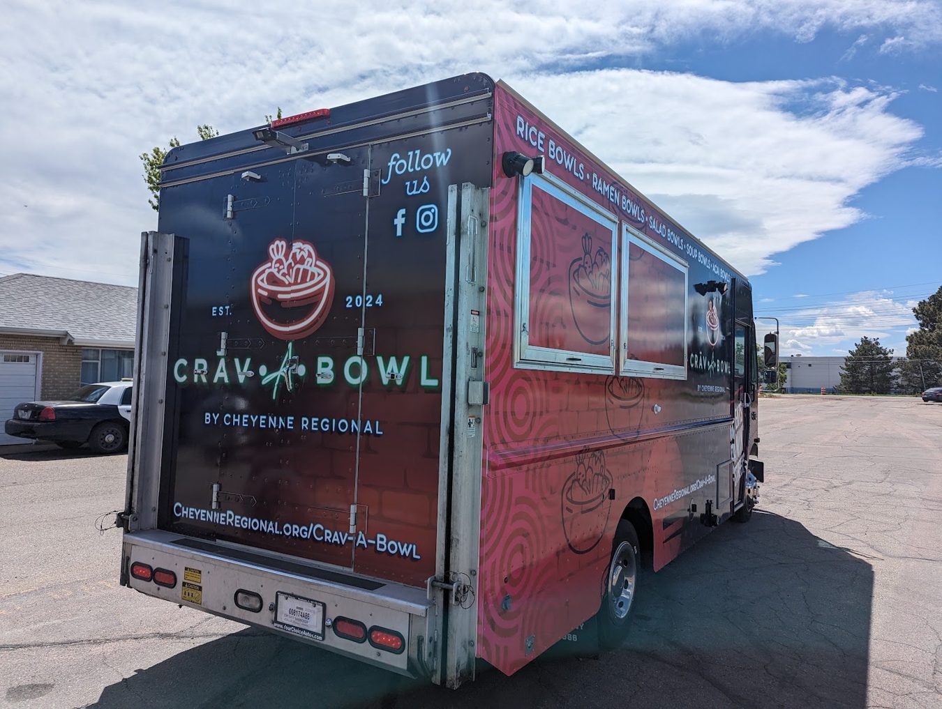 Rear three quarter view of the sixteen foot hospital food truck with the generator box and rear doors