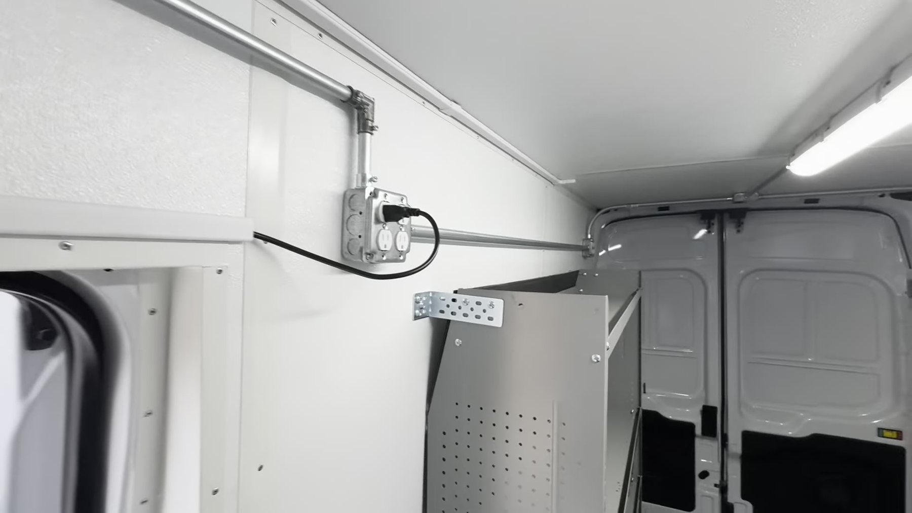 Wiring run in conduit with a junction box inside the Ford Transit outreach van