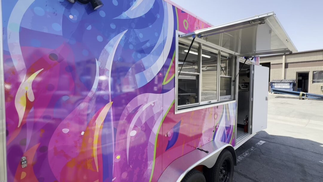 16ft Sizz'lin Street Bites food trailer in a pink and purple wrap, built for Longmont, Colorado