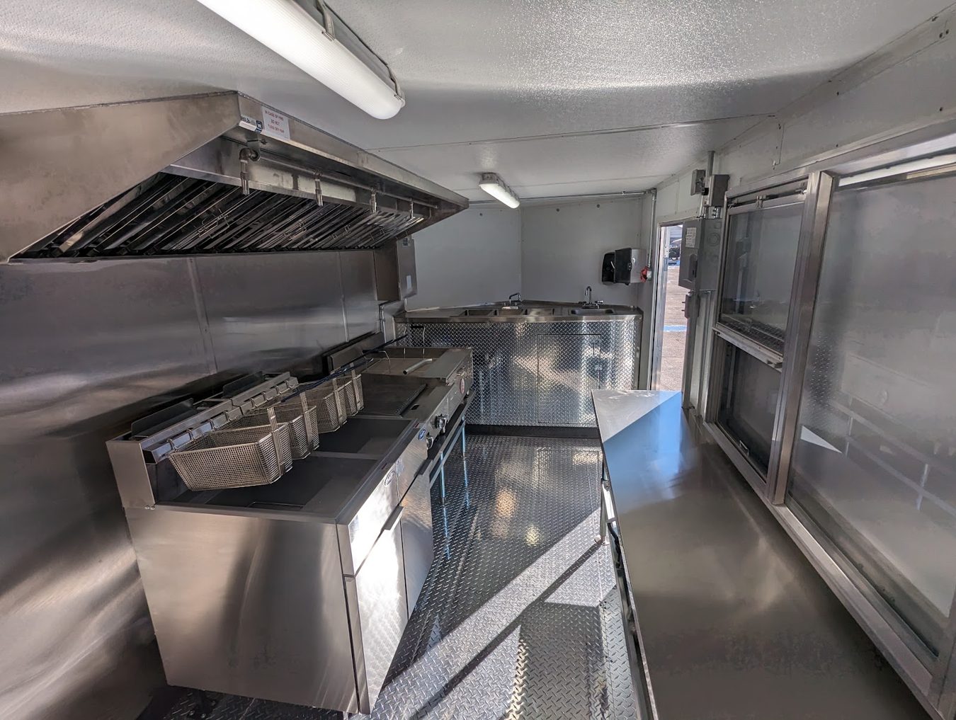 Inside the tempura trailer looking toward the service window with the hood on the left
