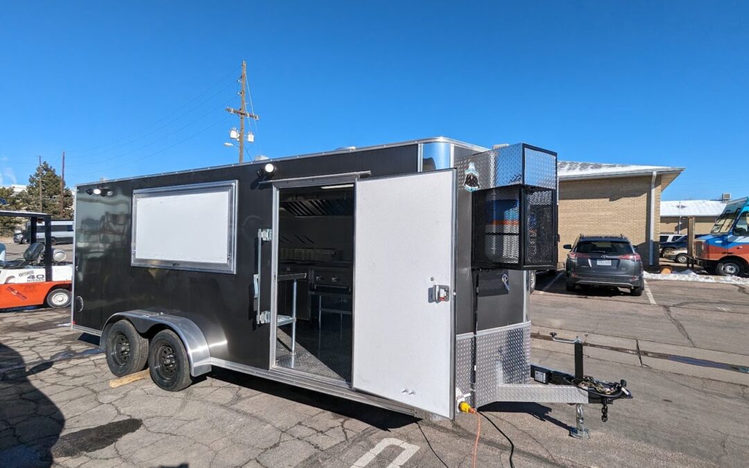 Eighteen foot grey tempura food trailer built by Mile High Food Trucks for Ten Tempura, Lander, Wyoming, curb side with the window and door open