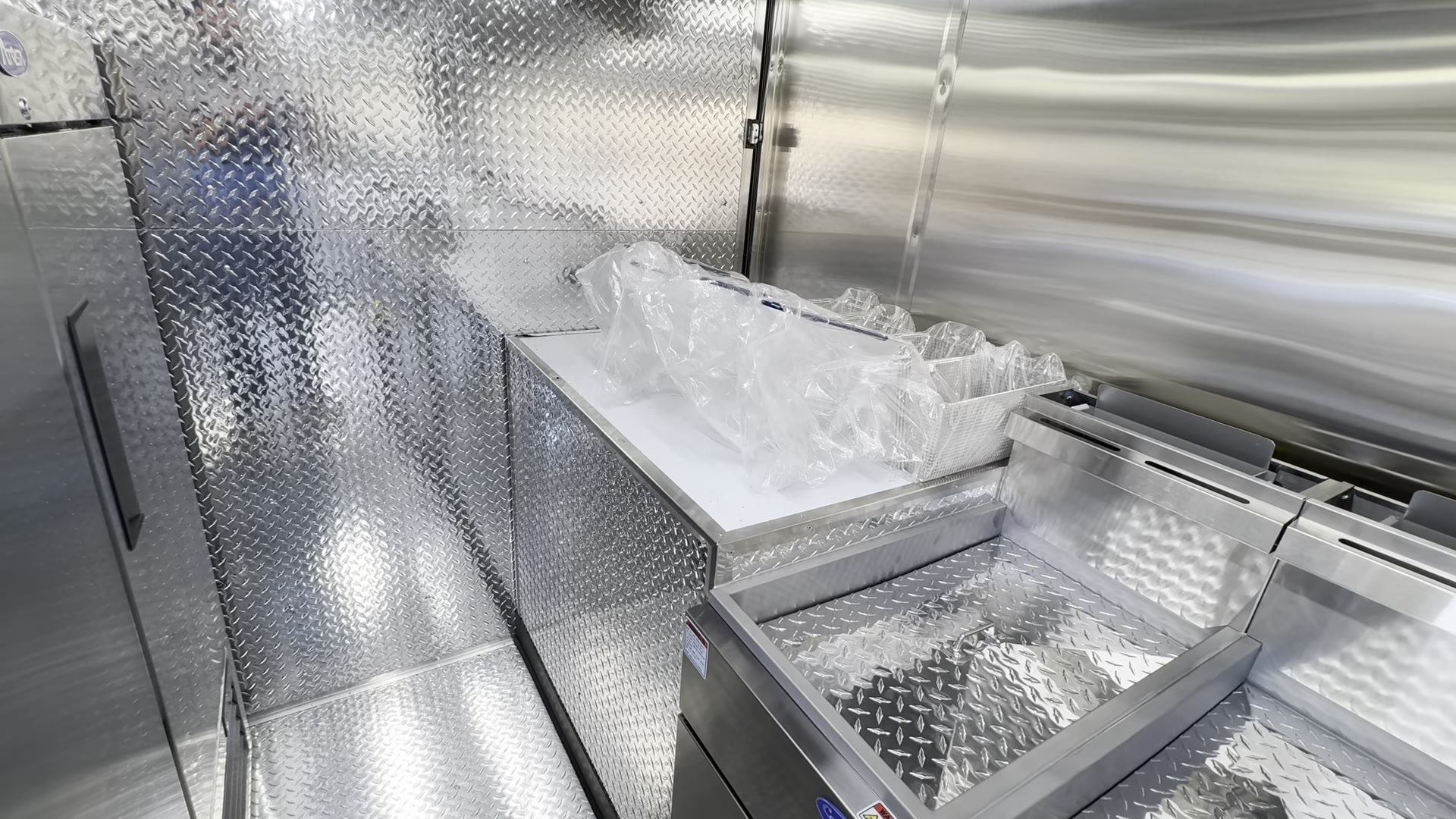 Two Atosa 40 pound floor fryers side by side in the food trailer