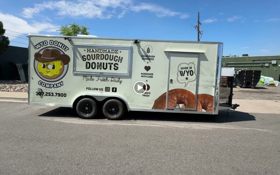 Twenty foot sourdough donut trailer built by Mile High Food Trucks for Wyo Donut Company, Casper, Wyoming, curb side with the full wrap