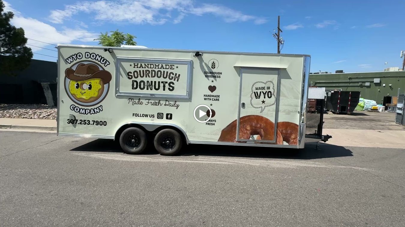 Twenty foot sourdough donut trailer built by Mile High Food Trucks for Wyo Donut Company, Casper, Wyoming, curb side with the full wrap