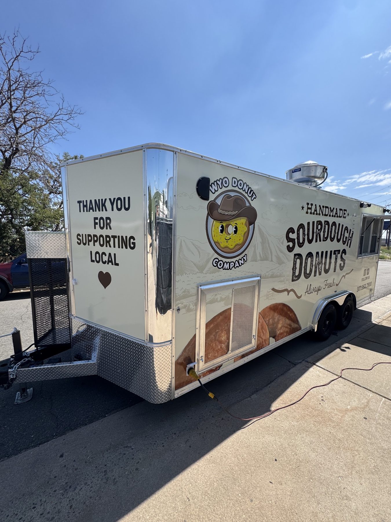 Rear of the Wyo Donut Company trailer with the thank you for supporting local message on the wrap