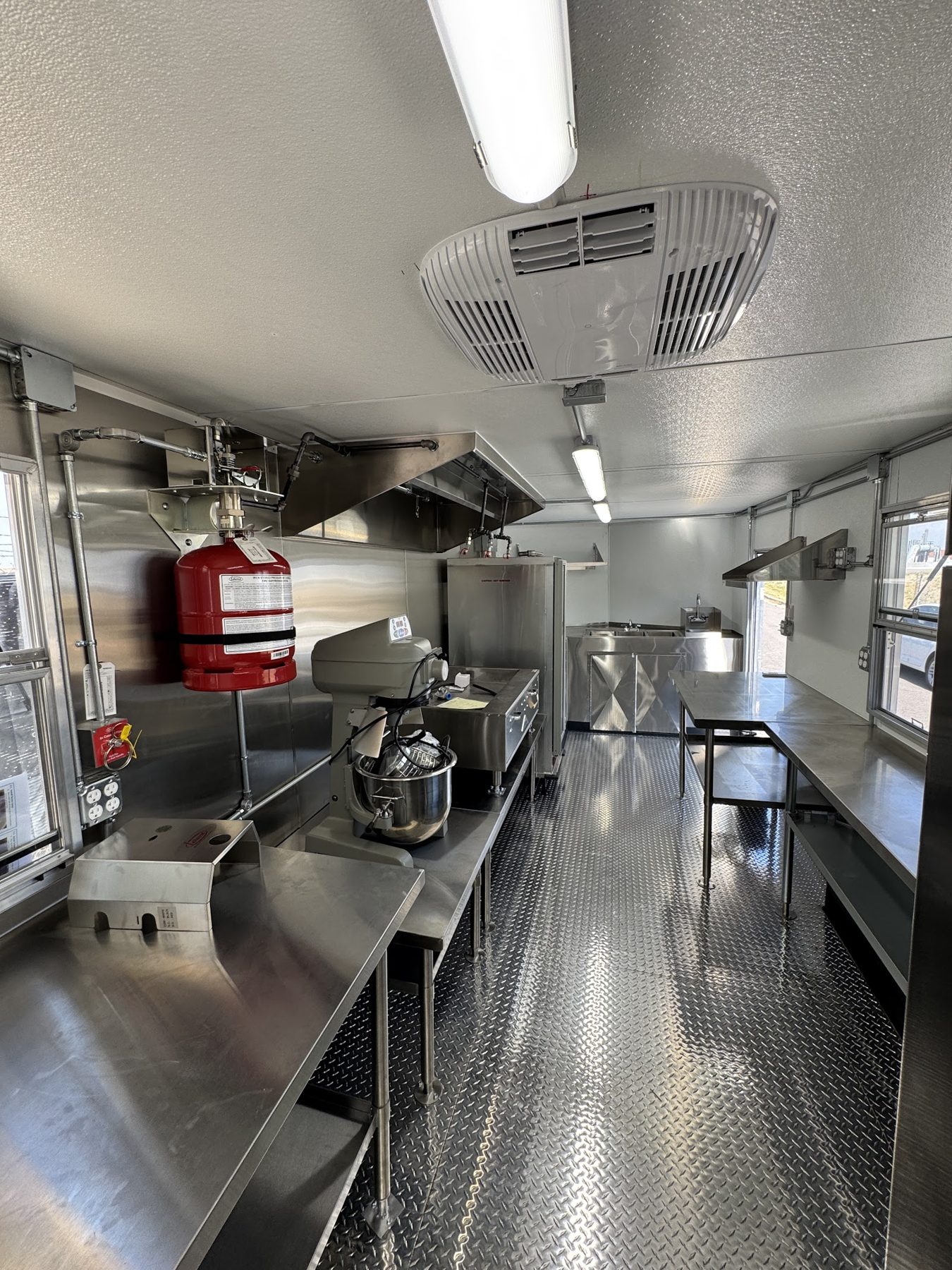 Six foot Type 1 hood with wet chemical fire suppression cylinder and the rooftop air conditioner inside the donut trailer